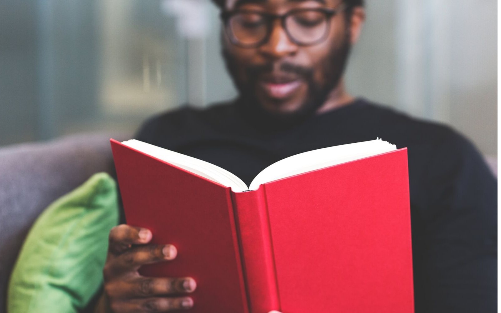 A person reads a red book.